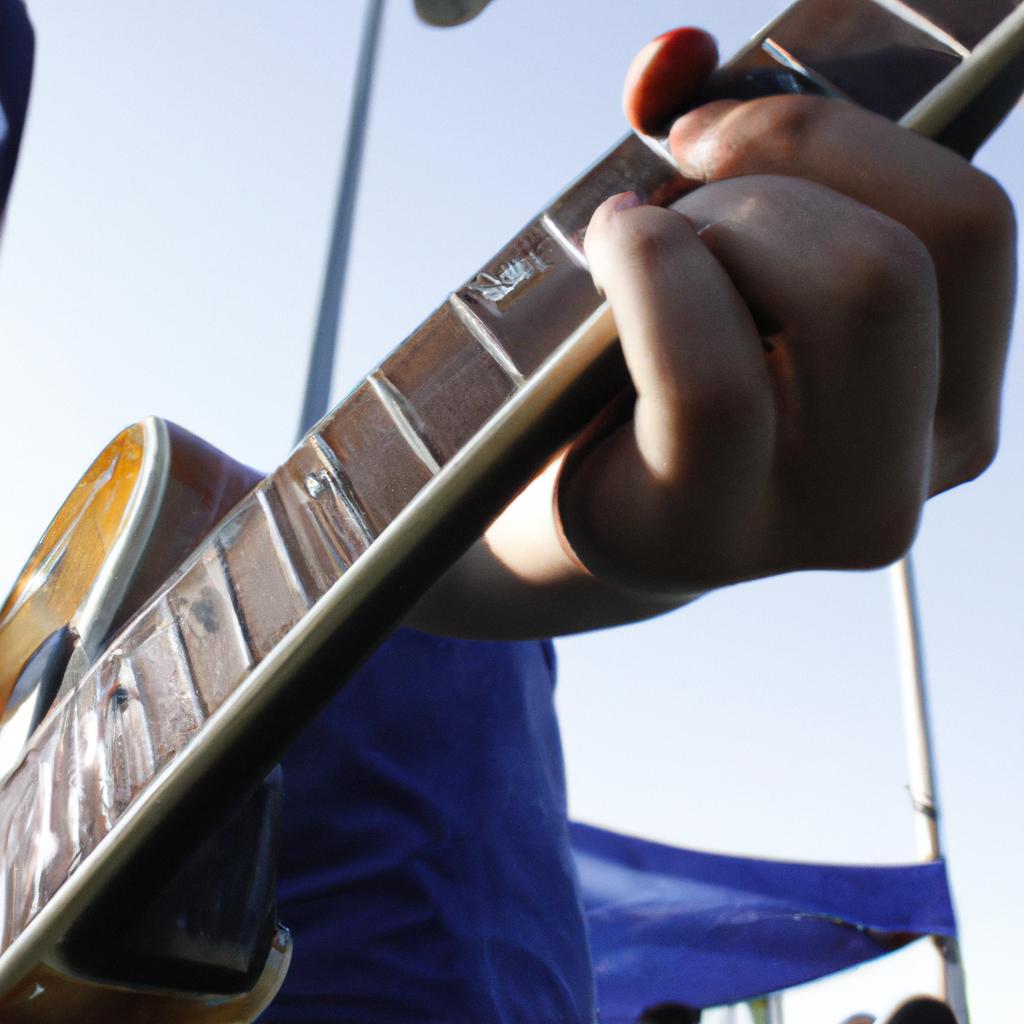 Person playing guitar at festival